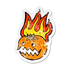 Retro Distressed Sticker Of A Cartoon Flaming Pumpkin Stock Image