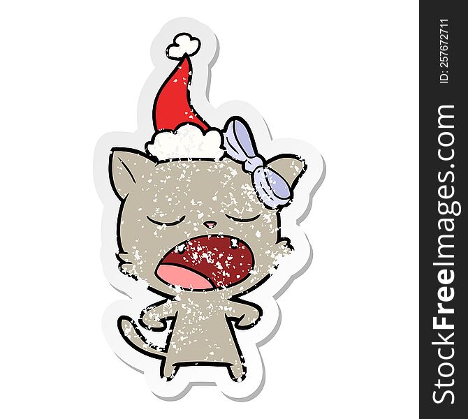 distressed sticker cartoon of a yawning cat wearing santa hat