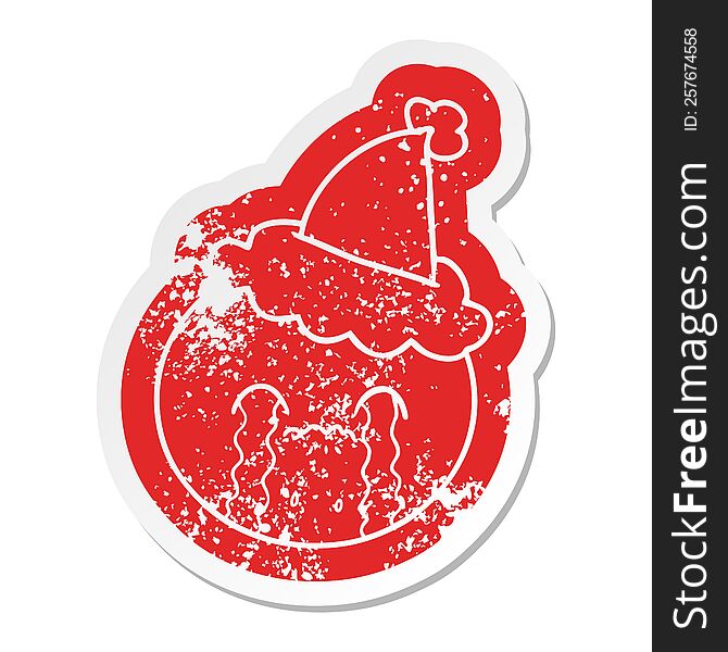 cartoon distressed sticker of a orange wearing santa hat