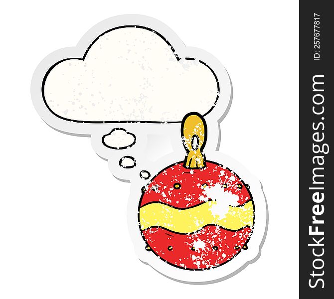 cartoon christmas bauble with thought bubble as a distressed worn sticker