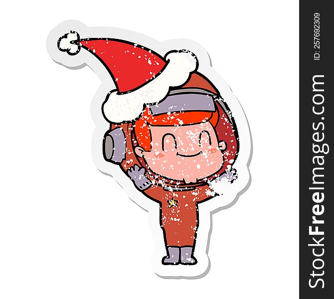 happy hand drawn distressed sticker cartoon of a astronaut man wearing santa hat