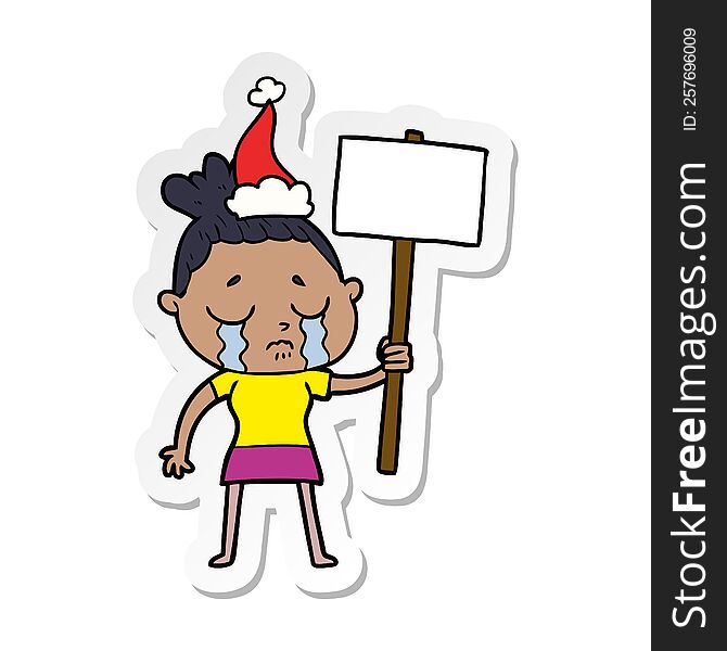 hand drawn sticker cartoon of a crying woman with protest sign wearing santa hat