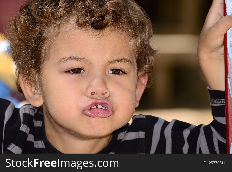 A boy making a silly face, with a big toothy smile. A boy making a silly face, with a big toothy smile