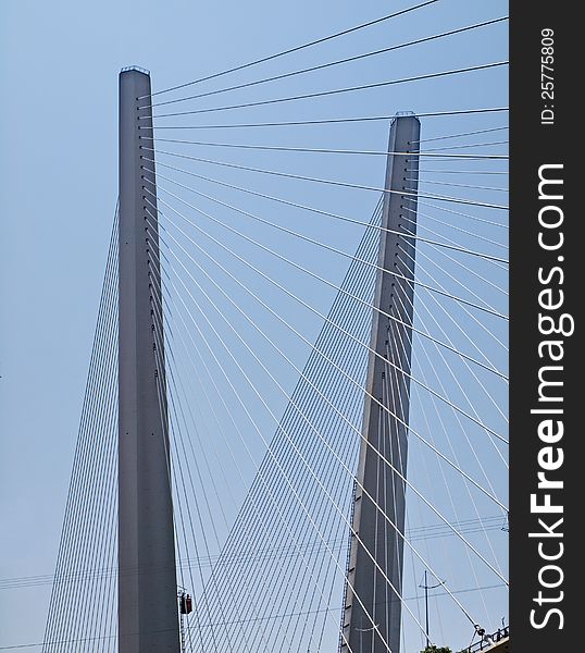 Pylons strung with guys. Detail of the bridge across the Golden Horn Bay, Vladivostok, Russian