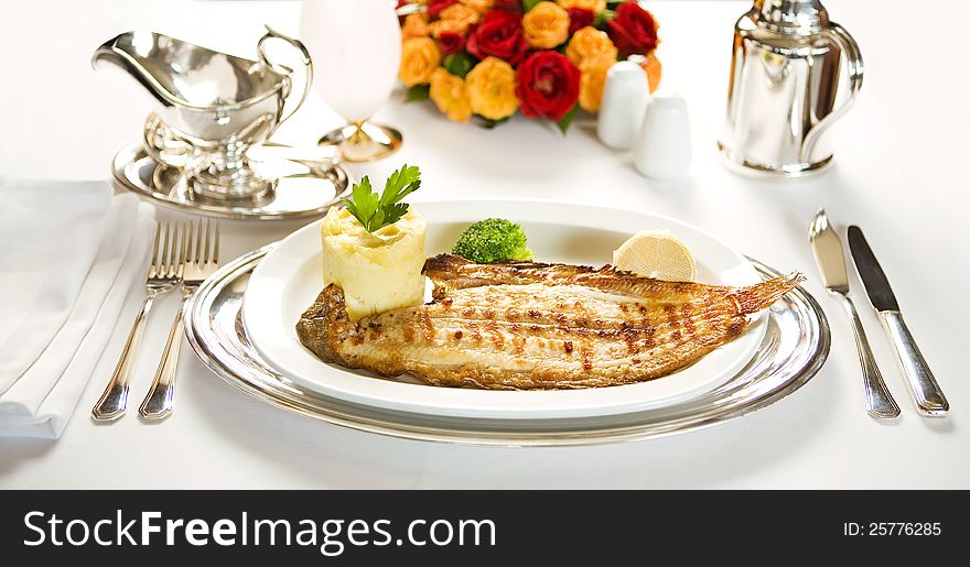 Fish with mashed potatoes and vegetables in a dish. Fish with mashed potatoes and vegetables in a dish