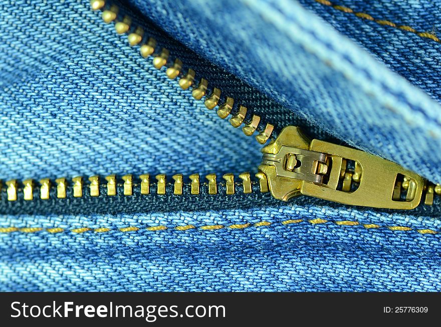 A closed-up of new blue jeans with shining zip. A closed-up of new blue jeans with shining zip.