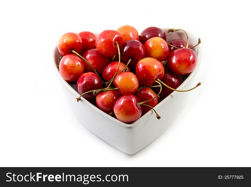 Cherries in the bowl isolated on white