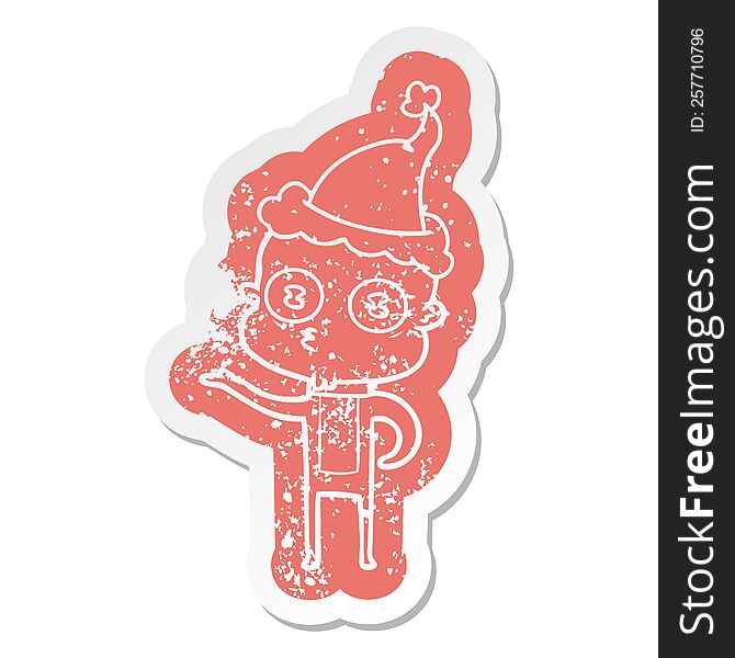 cartoon distressed sticker of a weird bald spaceman wearing santa hat