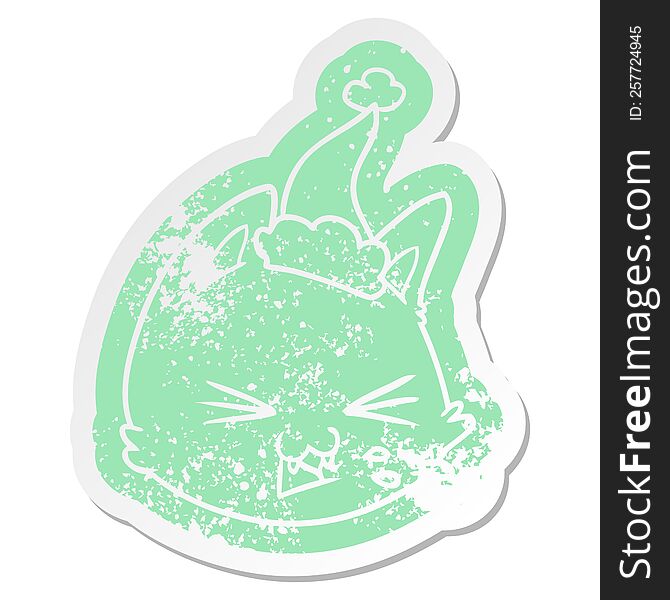 spitting quirky cartoon distressed sticker of a cat face wearing santa hat