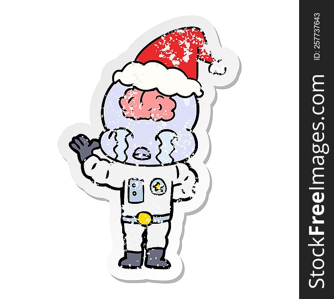 hand drawn distressed sticker cartoon of a big brain alien crying wearing santa hat