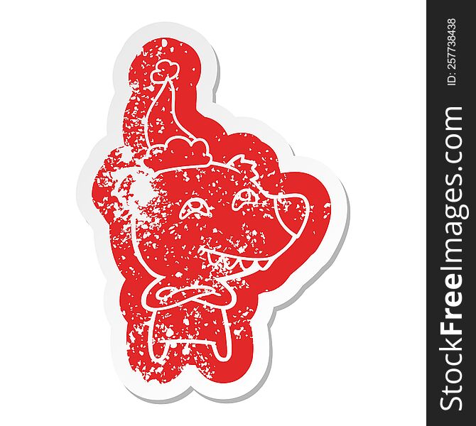 quirky cartoon distressed sticker of a bear showing teeth wearing santa hat