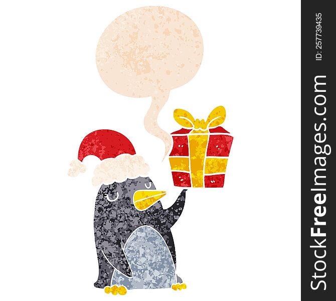 cartoon penguin with christmas present with speech bubble in grunge distressed retro textured style. cartoon penguin with christmas present with speech bubble in grunge distressed retro textured style
