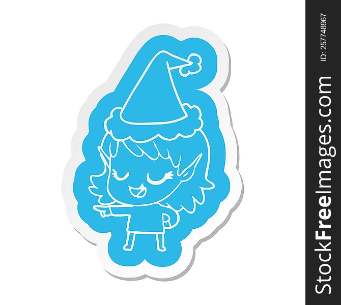 happy quirky cartoon  sticker of a elf girl pointing wearing santa hat