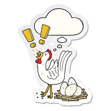 Cartoon Chicken Laying Egg And Thought Bubble As A Printed Sticker Stock Photo