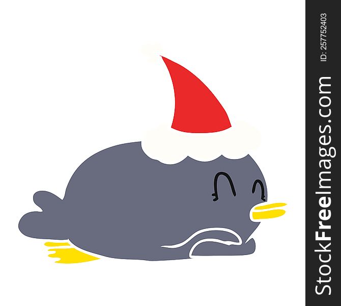 penguin lying on belly wearing santa hat