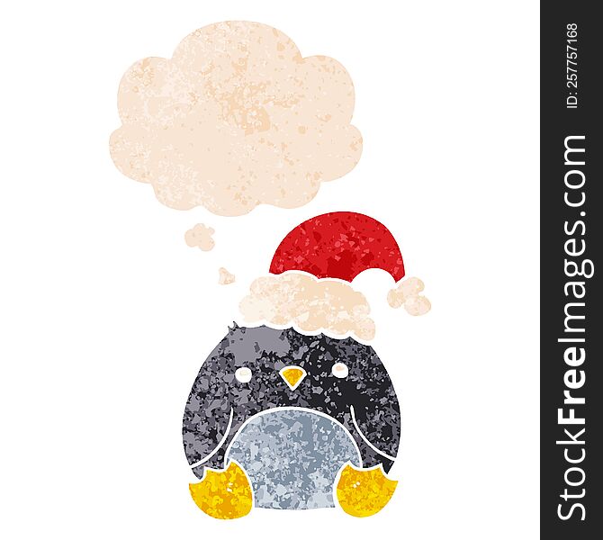 cute cartoon penguin wearing christmas hat and thought bubble in retro textured style