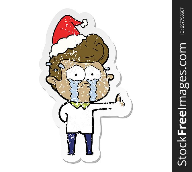 Distressed Sticker Cartoon Of A Crying Man Wearing Santa Hat