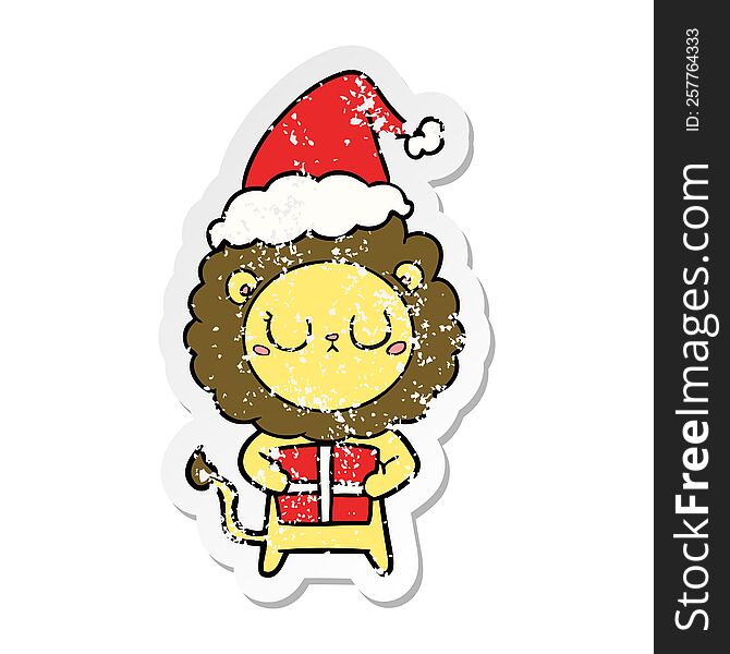 Distressed Sticker Cartoon Of A Lion With Christmas Present Wearing Santa Hat