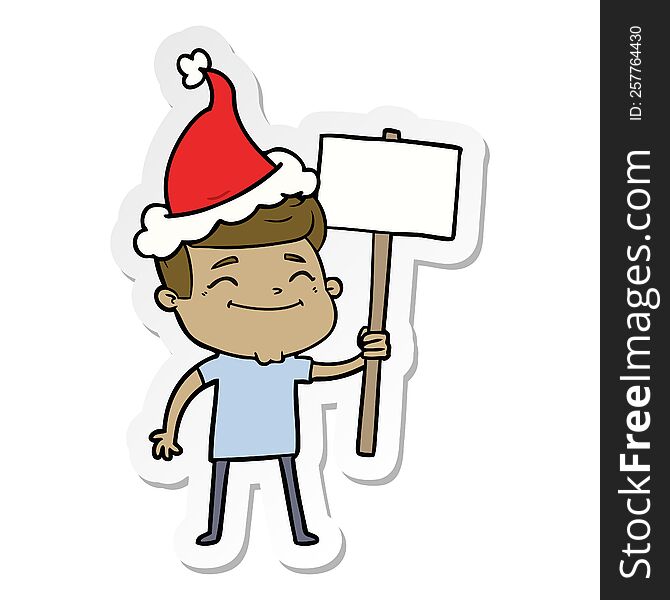 happy hand drawn sticker cartoon of a man with placard wearing santa hat. happy hand drawn sticker cartoon of a man with placard wearing santa hat