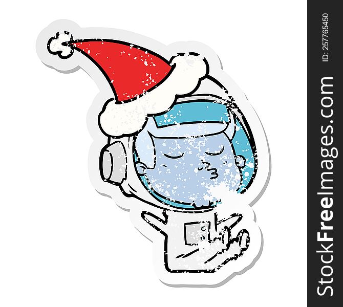 hand drawn distressed sticker cartoon of a confident astronaut wearing santa hat
