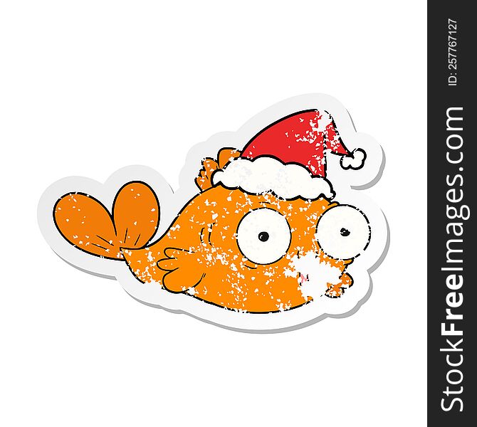 Happy Goldfish Distressed Sticker Cartoon Of A Wearing Santa Hat