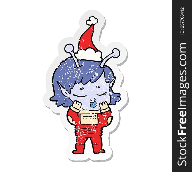 hand drawn distressed sticker cartoon of a alien girl wearing santa hat