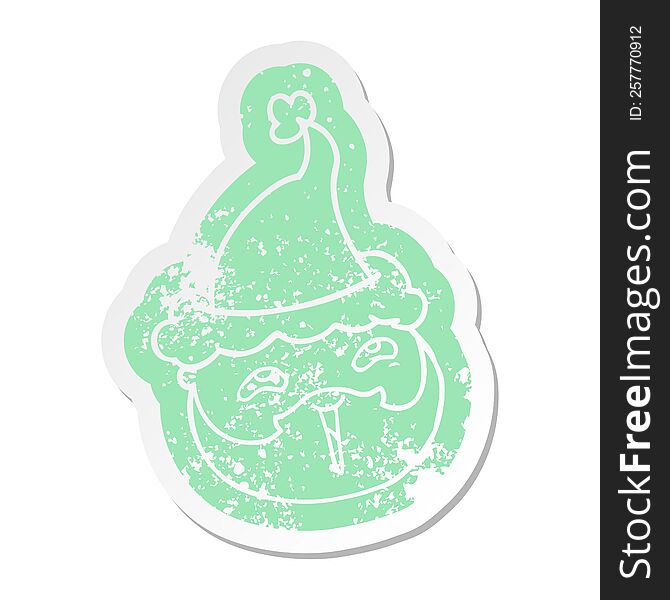 quirky cartoon distressed sticker of a male face with beard wearing santa hat