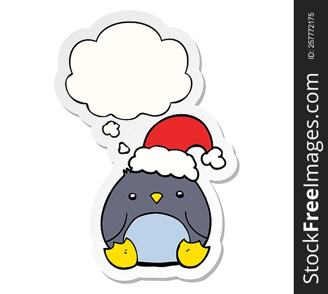 cute cartoon penguin wearing christmas hat with thought bubble as a printed sticker