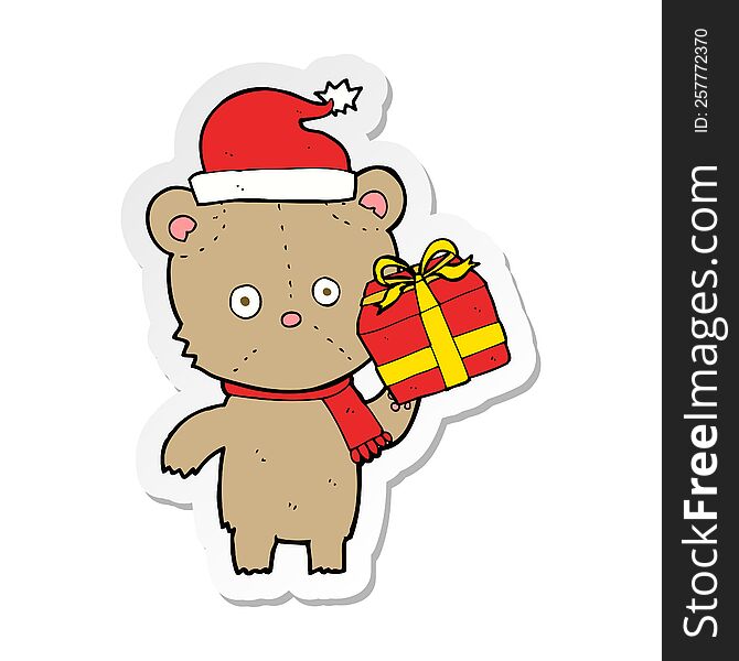 sticker of a cartoon christmas teddy bear with present