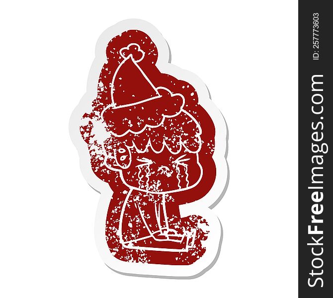 quirky cartoon distressed sticker of a boy crying wearing santa hat