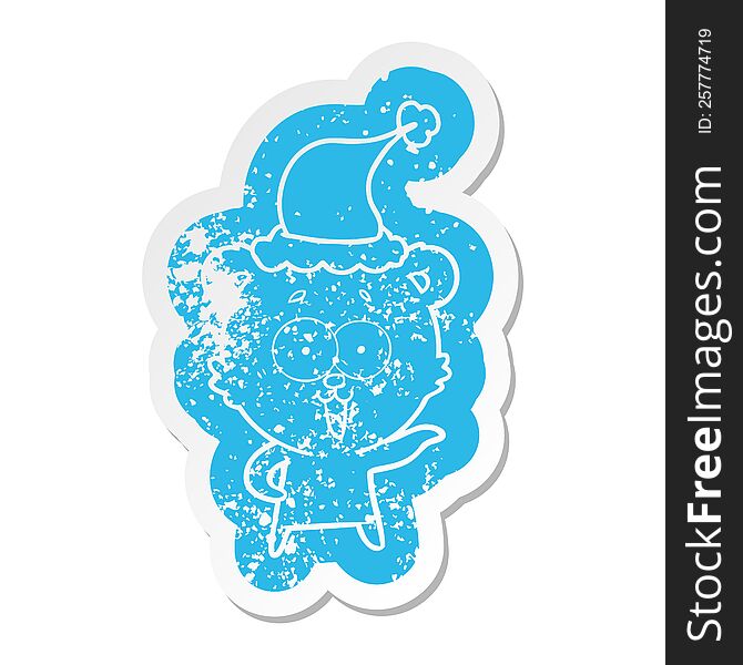 laughing teddy  bear cartoon distressed sticker of a wearing santa hat