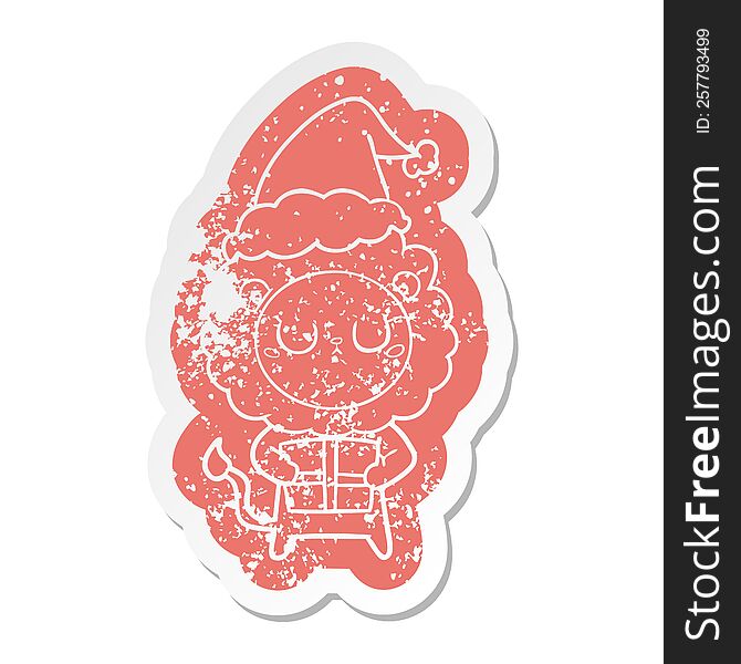 quirky cartoon distressed sticker of a lion with christmas present wearing santa hat