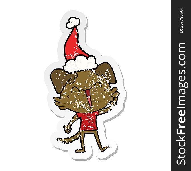 happy little dog hand drawn distressed sticker cartoon of a wearing santa hat