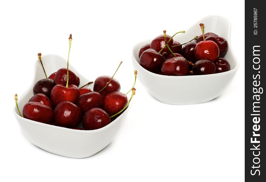 Fresh Ripe Perfect Sweet Cherry in two white bowls isolated on white background