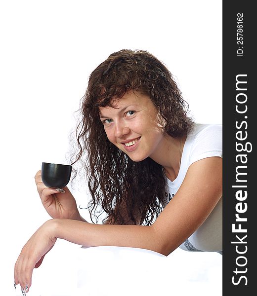 Portrait of the dark-haired girl in white with a cup of coffee, white background. Portrait of the dark-haired girl in white with a cup of coffee, white background