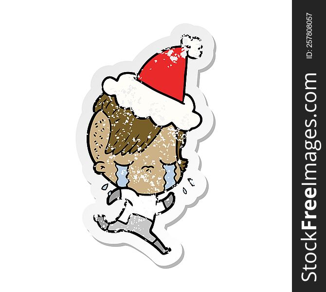 hand drawn distressed sticker cartoon of a crying girl wearing space clothes wearing santa hat