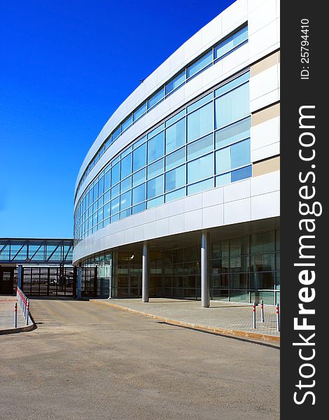 Photo of modern building of the airport against blue sky. Photo of modern building of the airport against blue sky