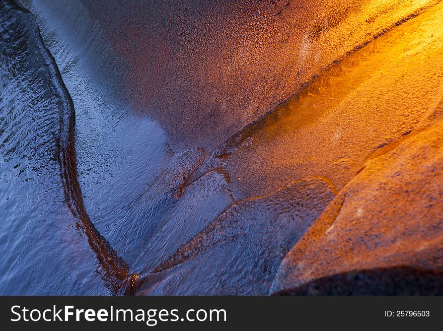 Golden light on sandy beach with water receding. Golden light on sandy beach with water receding