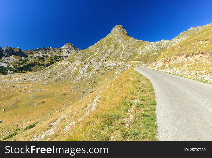 Asphalt road winding through a mountain in Zabliak Montenegro. Asphalt road winding through a mountain in Zabliak Montenegro