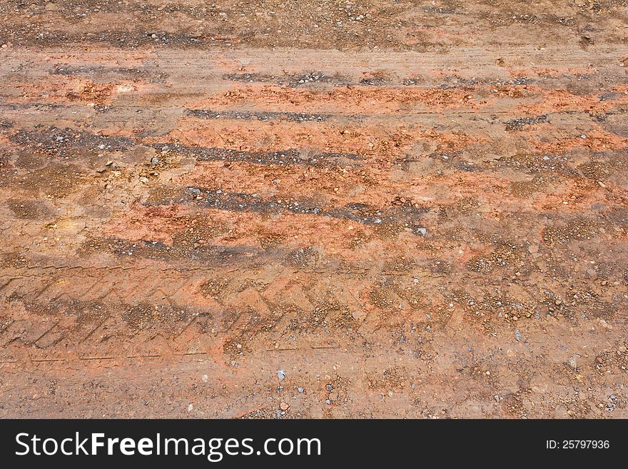 Surface of the ground at a rural road in the rain stops and traces its wheels. Surface of the ground at a rural road in the rain stops and traces its wheels.