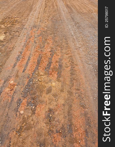 Surface of the ground at a rural road in the rain stops and traces its wheels. Surface of the ground at a rural road in the rain stops and traces its wheels.