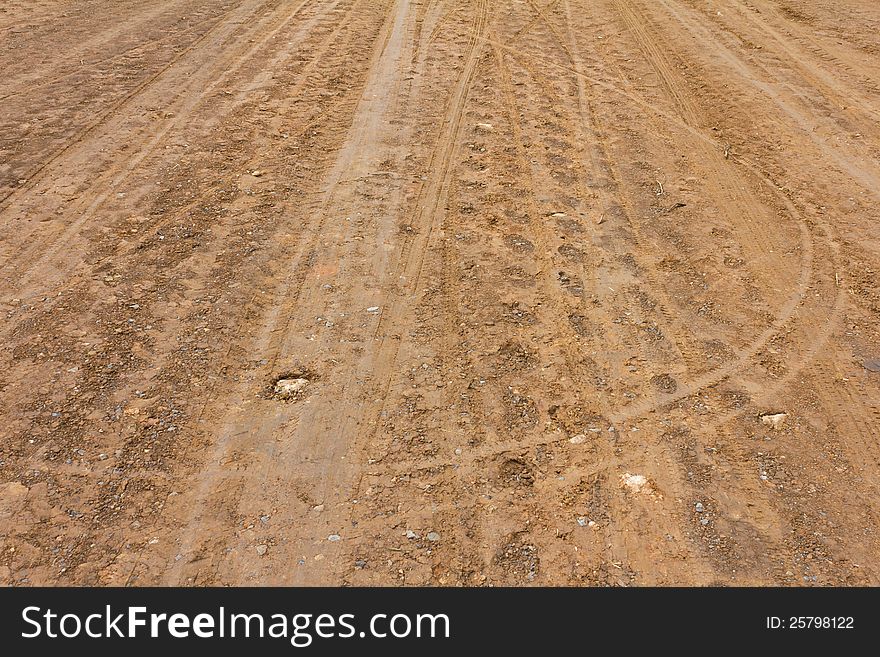 Surface of the ground at a rural road in the rain stops and traces its wheels. Surface of the ground at a rural road in the rain stops and traces its wheels.