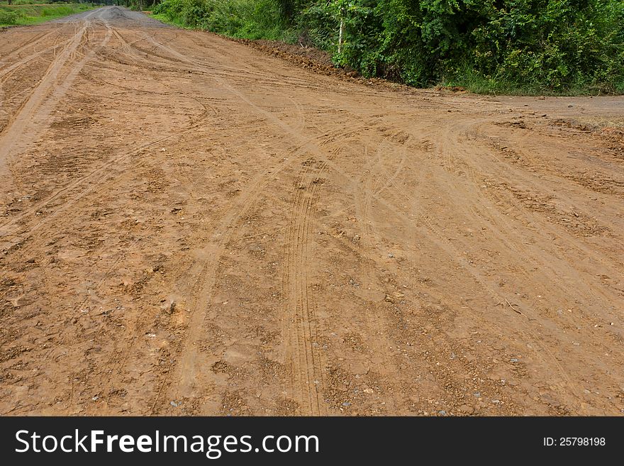 Traces of the wheels of cars and motorcycles on the roads in rural areas on the ground after a rain. Traces of the wheels of cars and motorcycles on the roads in rural areas on the ground after a rain.