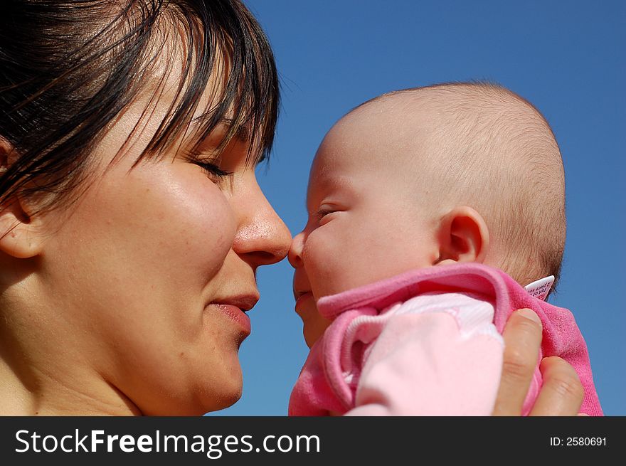 Mother and newborn girl on sky background. Mother and newborn girl on sky background