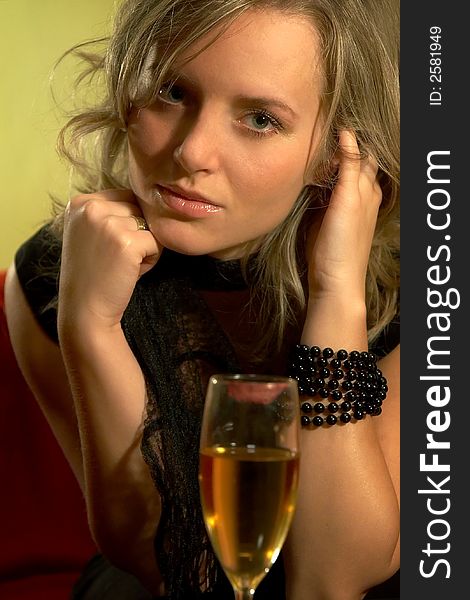 Girl with beads and glass of wine