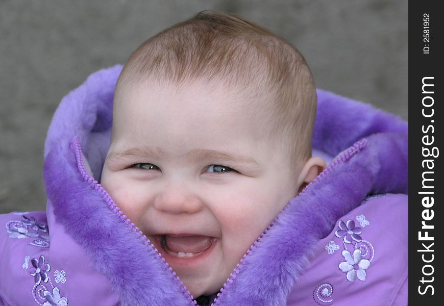Pretty Smiling Baby In Purple