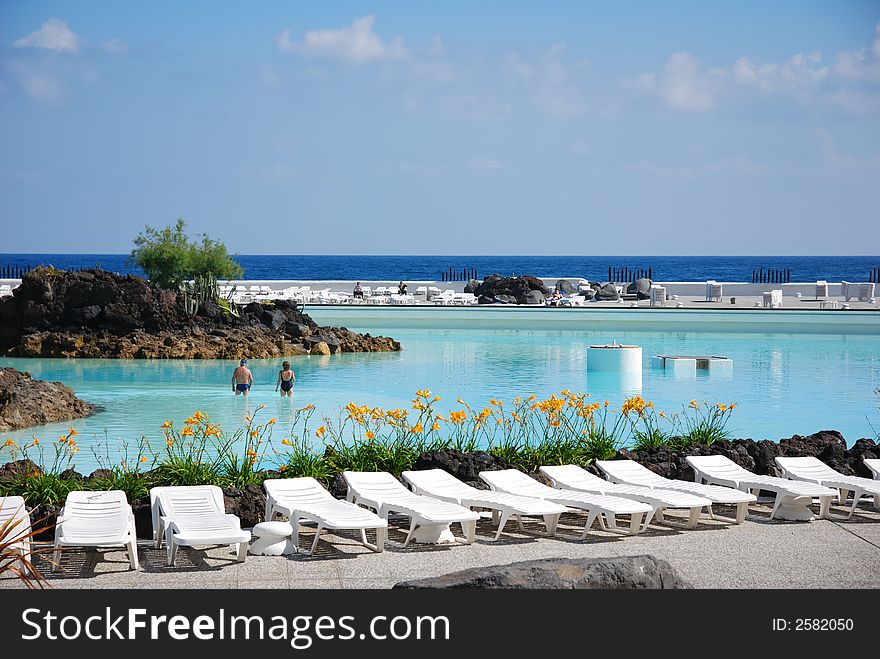 Couches at swimming pool of a tourist resort