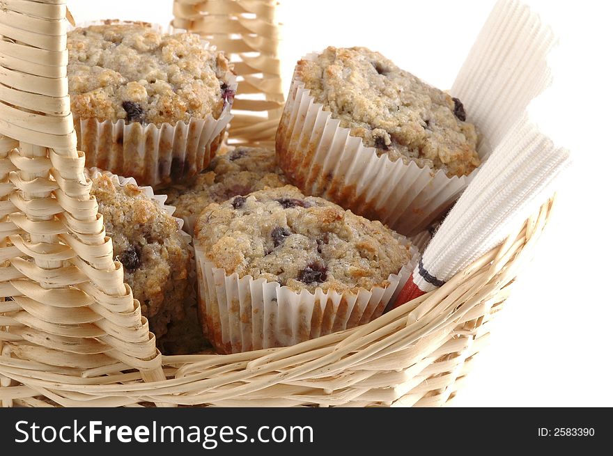 Close-up of fresh baked muffins in a basket. Close-up of fresh baked muffins in a basket.