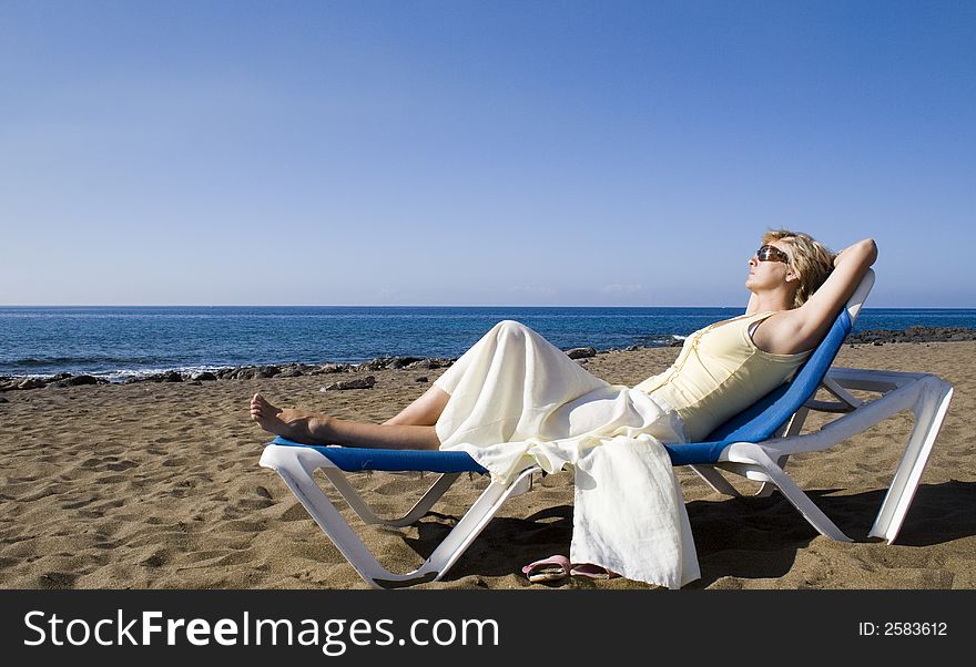 Nice woman resting on the beach in the summer. Nice woman resting on the beach in the summer