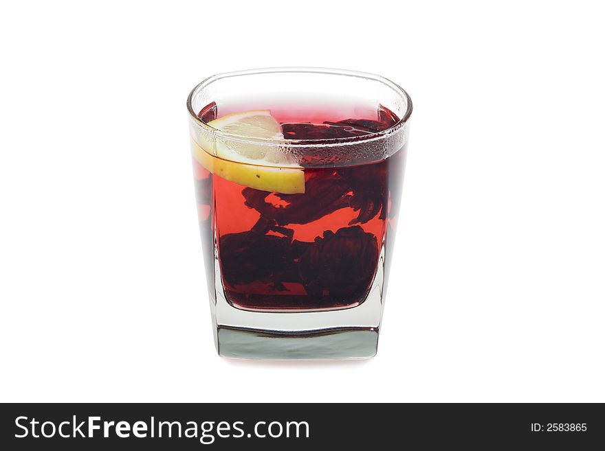 Glass of bright-red hot hibiscus tea. Isolated on white background.